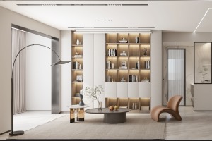 在客廳區域，靠墻設計了嵌入式書柜，原木色書柜與暖白色墻面合二為一，在視覺上豐富了客廳的層次與視野。