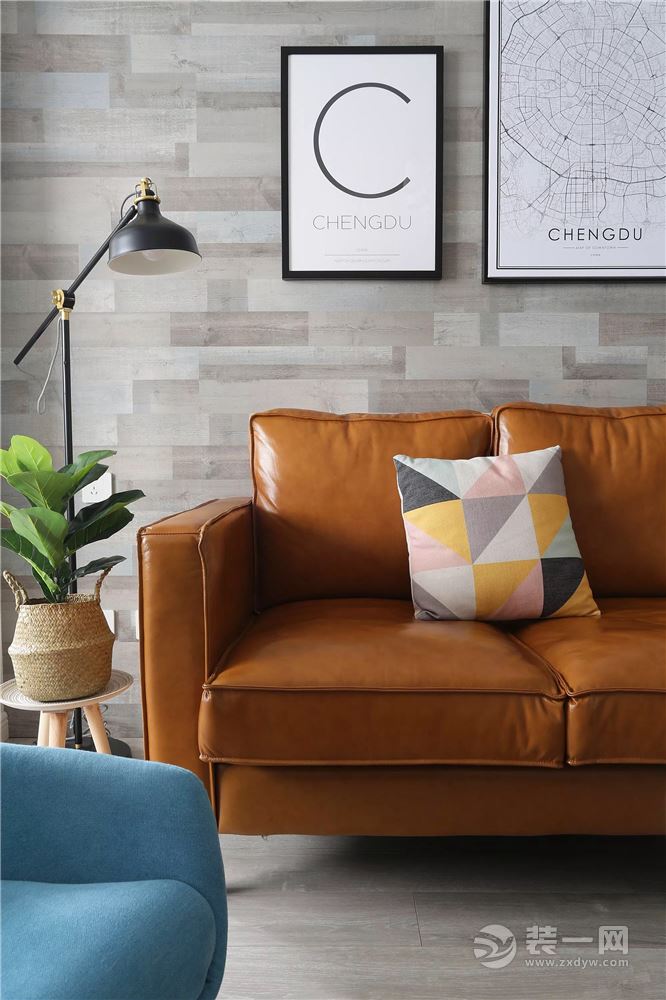姜黄色的皮沙发，搭配复古仿木的沙发墙壁布，在简约黑白画的装饰点缀下，显得奢华而又年轻简约；