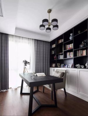 ▲ 书房整体延续灰白用色，简洁的书桌椅，黑白搭配的半开放式书柜作背景