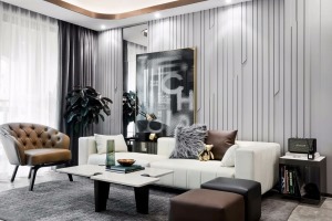 客厅以灰+白两色打造，纯白色的皮沙发搭配深色的抱枕，相互融合，背景墙的线条与金属的点缀，品质而放松。