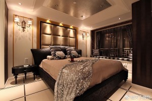 卧室充满暖色调，豪华双人床、古典壁灯、华丽床头墙装饰，尽显奢华之感