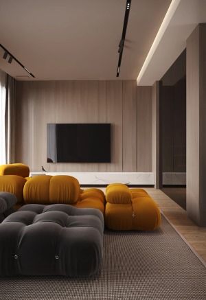客厅的色彩以橘黄色和灰黑色的沙发为主，柔软的体积和优美的线条弧度让空间更具现代感，明暗色系的结合让氛