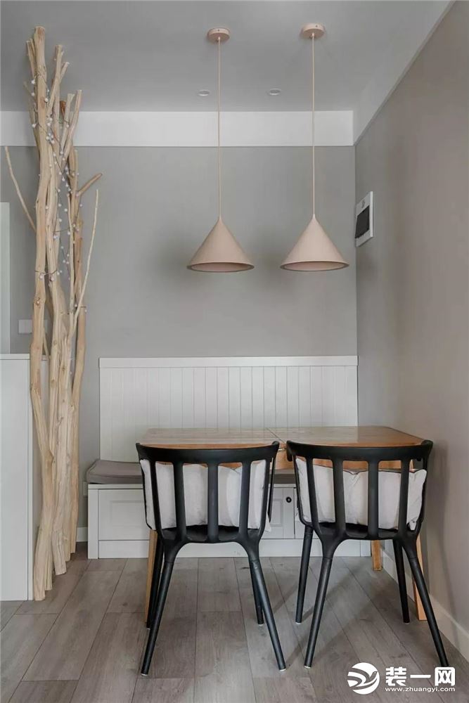 ▲两面靠墙的餐厅，以卡座设计配合镂空的餐桌椅弥补了空间的紧凑感，垂下的两盏粉色吊灯，也补足了浪漫情调