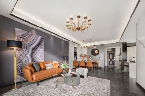 高级灰纯色沙发背墙设计，与传统样板房空间语言有着明显的距离感，客厅空间墙呈现灰与白碰撞色，相互对立又