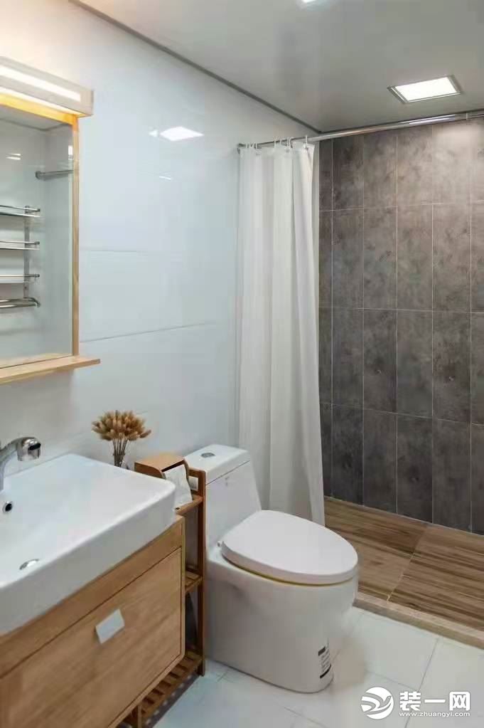 卫生间浴室柜柜门也是采用原木色，洗浴区域地砖采用仿木地板的瓷砖