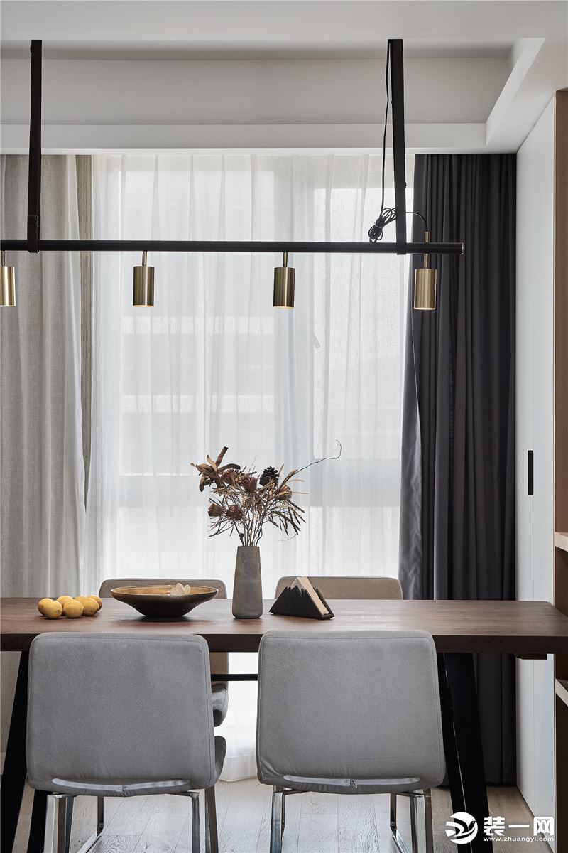 黑色灯杆的多头灯和黑色的桌角相呼应，增加了整体的现代味道，纯铜的灯头作为点缀色出现在空间。黑胡桃木的