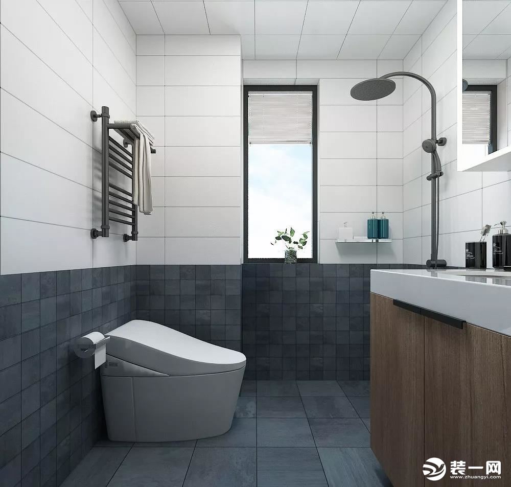 卫生间的墙面设计感独特，上面是白色，会让整个空间看上去明亮很多，下面是深灰色的瓷砖铺的，很耐脏又很沉