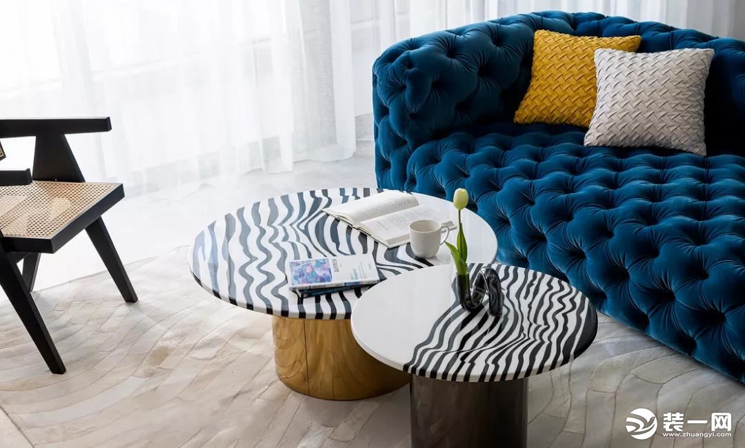 米色调地毯似一道道弧形海浪将沙发茶几包裹其中，线条与线条交相呼应，让室内呈现出自由烂漫的状态。