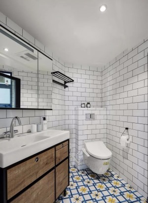  卫生间墙面采用网红小白砖和深灰色填缝，视觉上增大整个空间的亮度。地面铺贴了蓝黄两色搭配的小花砖，精