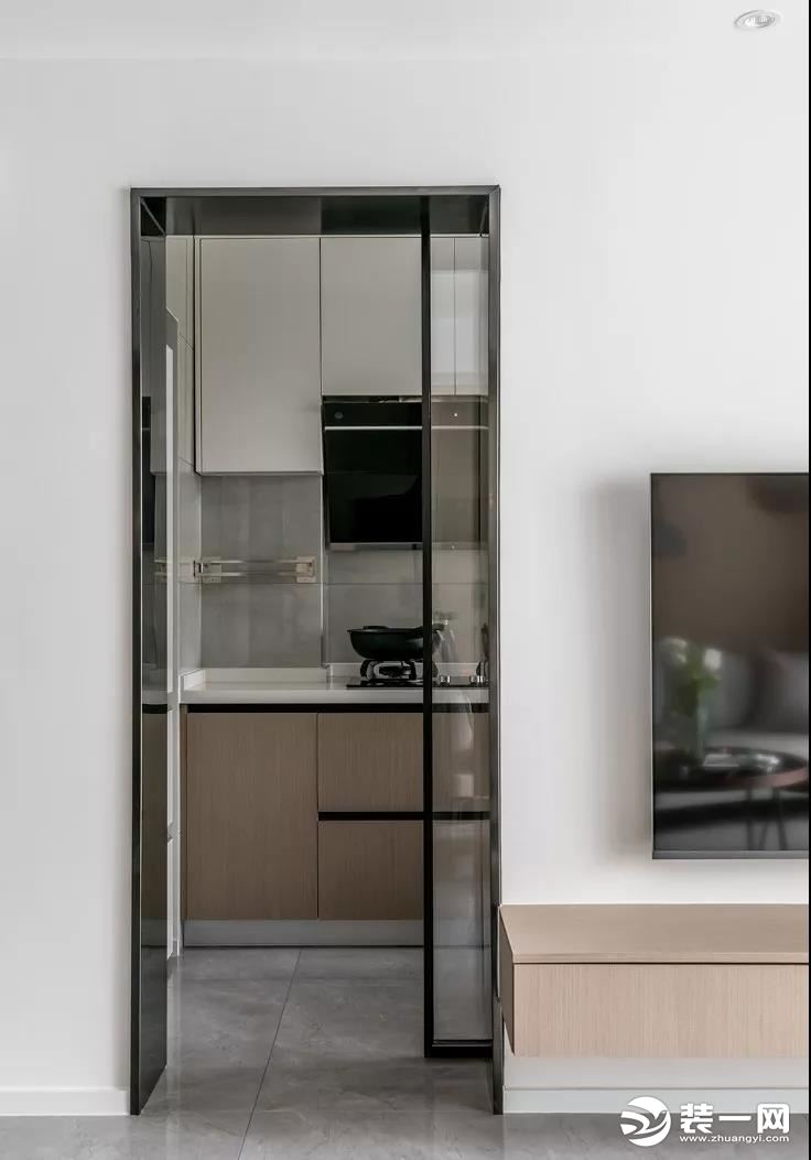  厨房利用黑框玻璃移门进行分隔，避免油烟溢出，也不影响采光。