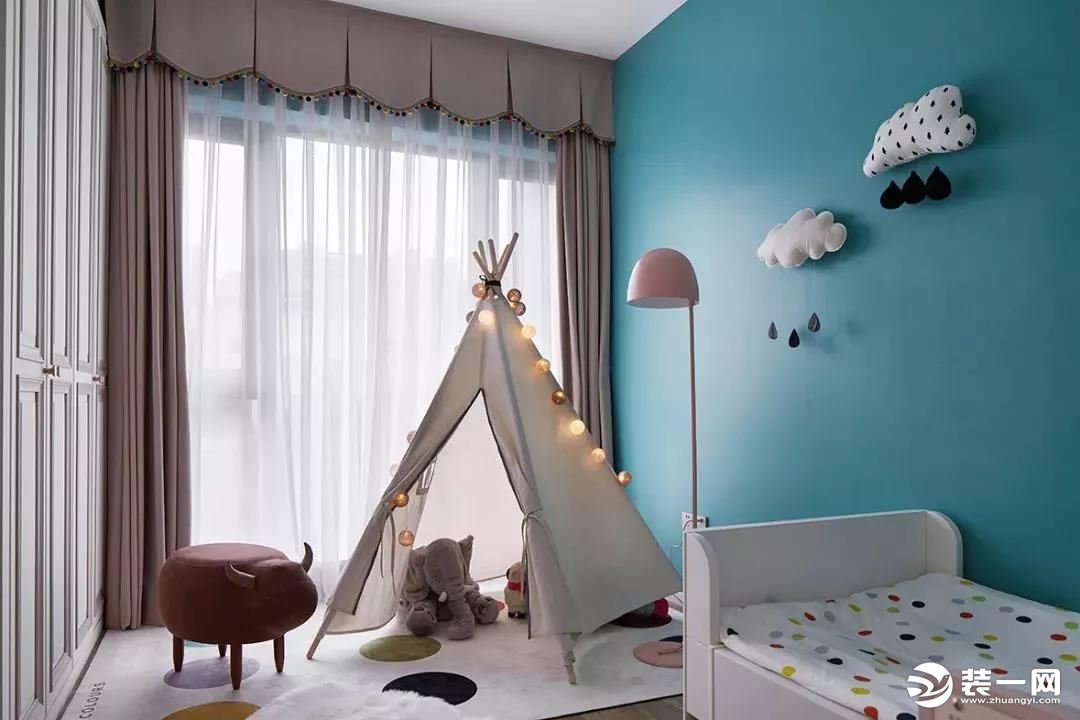 儿童房的空间就会更迷你一些，孔雀蓝的墙面上做了云朵的造型，靠窗铺上地毯和做个小帐篷