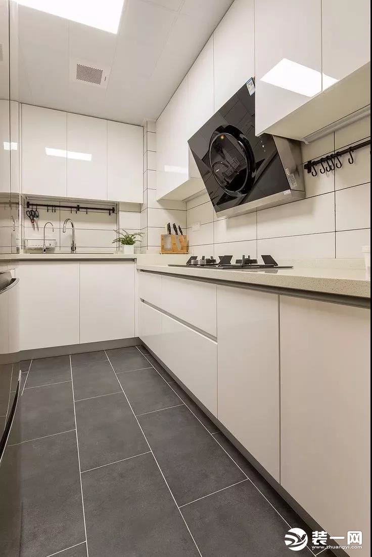 厨房内部的空间还算宽敞，L形的橱柜布局方案满足了使用需求，把冰箱也放在厨房内