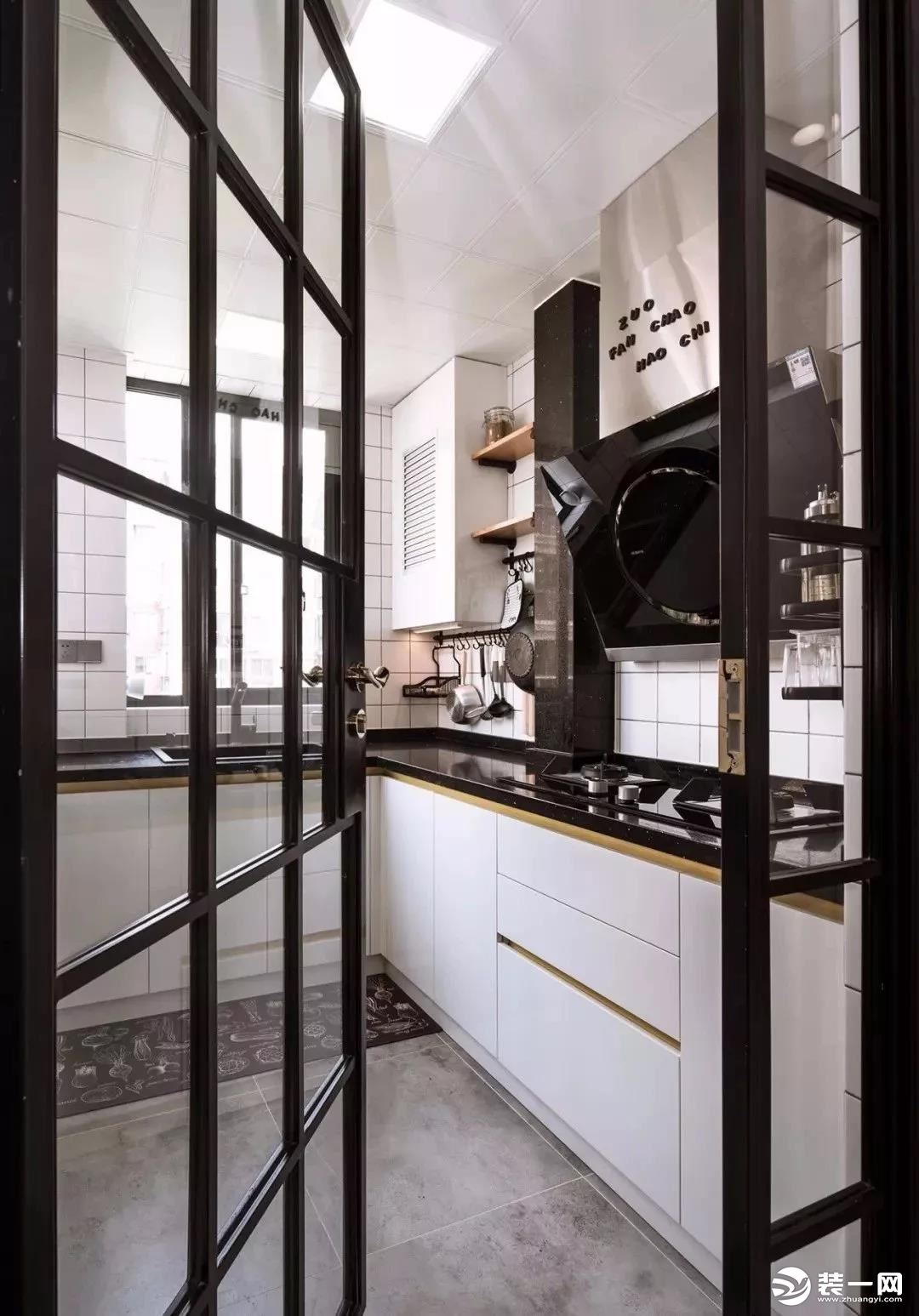 厨房与餐厅用黑框玻璃门隔开，透明隔断，有助于延伸空间视觉感。