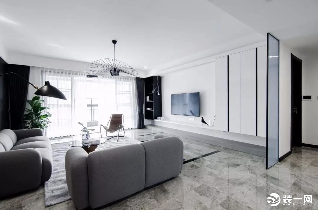 客厅的电视背景墙选择了中间留空刷白，周边做上收纳柜的设计，悬空的隔板和柜子连在一起