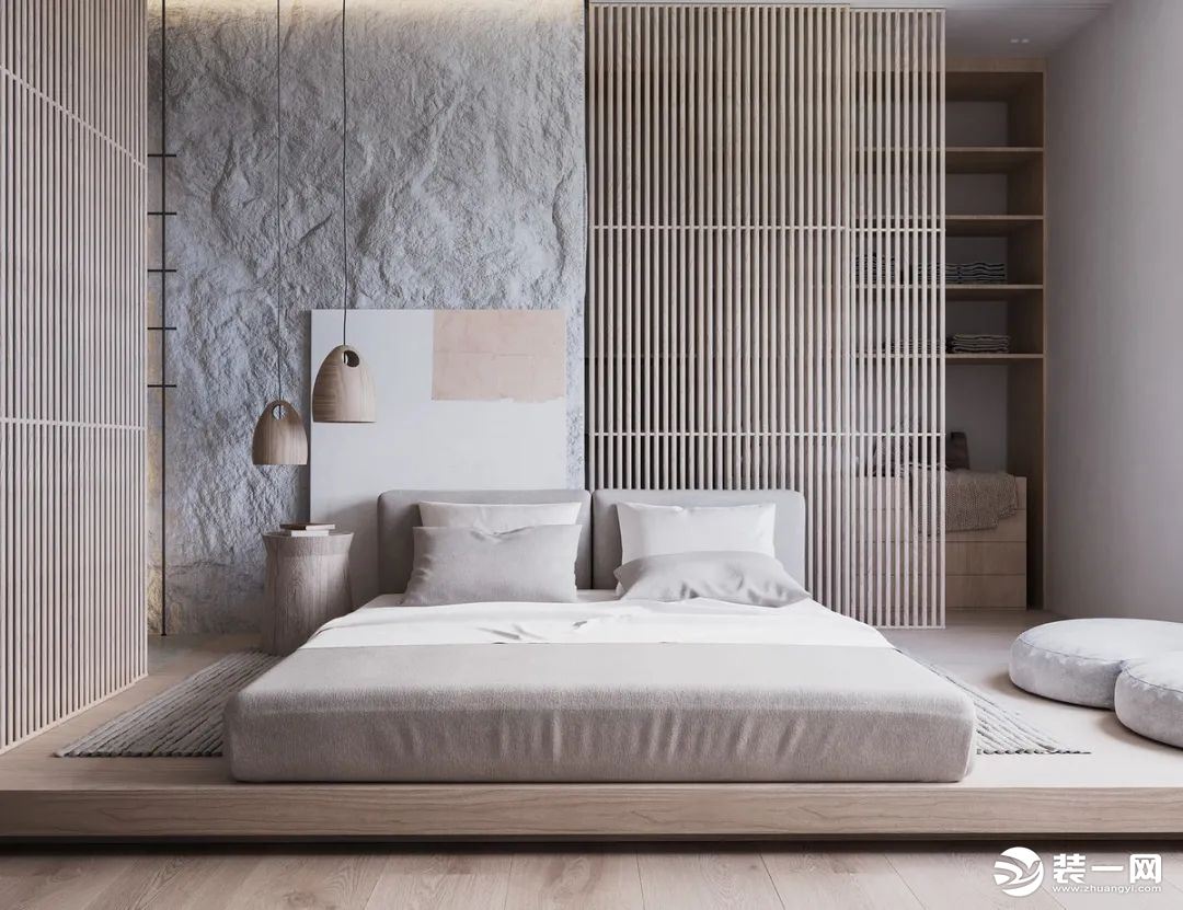 卧室床头墙采取自然粗糙的水泥材质与木质屏风设计，整个床铺区域装上一个抬高的地台，布置灰色的床垫床单，