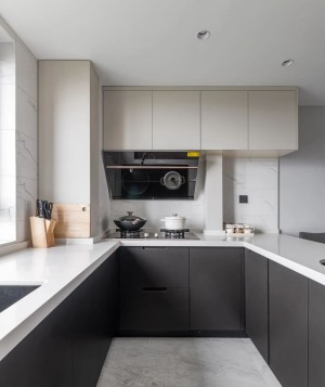 厨房采用U型布局，延伸出一个一体化中岛台，扩宽厨房操作台，又可以衔接餐厅。厨房黑白色的烤漆橱柜，采用