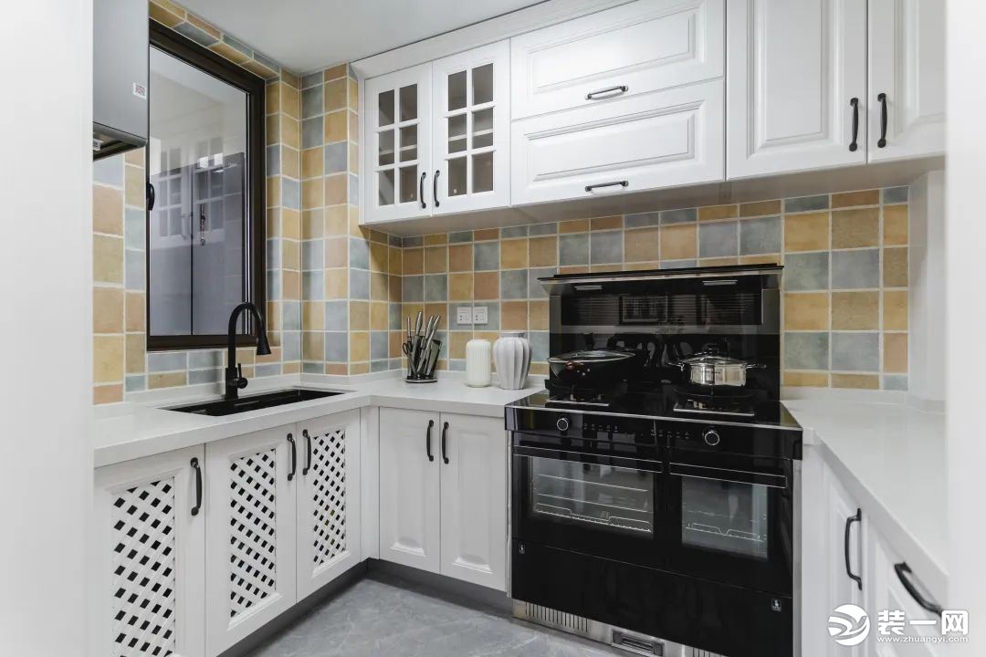 厨房以白色橱柜搭配复古小方砖，构筑简练不失雅致的烹饪空间。呈U型布局，洗切炒动线一气呵成，灰色地砖奠