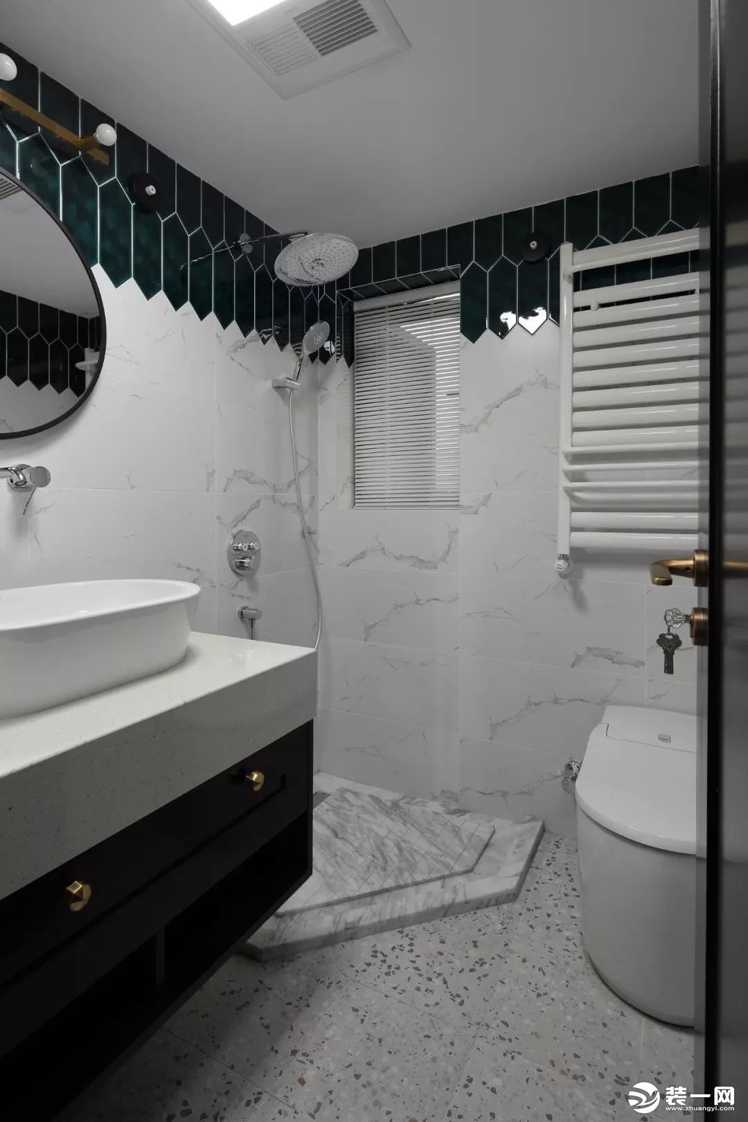 ▲卫生间以水磨石地面，淋浴区这是大理石质感的，搭配雅白墙面砖，墙身顶部是墨绿色的六边长条砖，带来一种