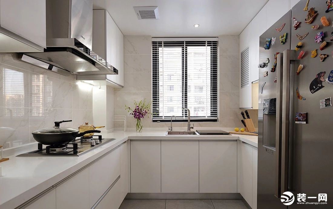 厨房U字形布局，提供丰富的收纳与储物空间。整体以白色为主调，干净敞亮。