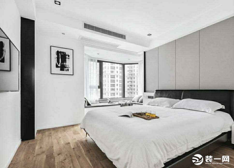 主卧的床头背景墙采用硬包设计.黑色的皮质床搭配.原木地板.使得空间优雅而更高级