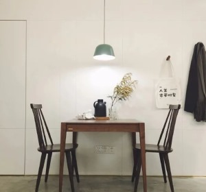 黑胡桃木的餐桌椅看似简单，但实际却非常有质感，桌上的茶壶和插花很有意境。