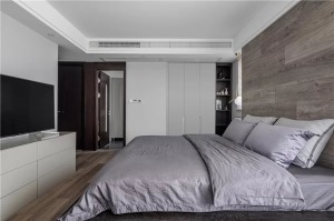 卧室整体现代大方的空间基础，床头墙是木地板上墙的设计，搭配上大尺寸的床铺，灰色的床单布置，为卧室提供