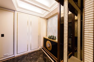 位于同一立面的柱体、镜子与鞋柜，都在金箔勾框的修饰后，有了齐整华丽的风格。