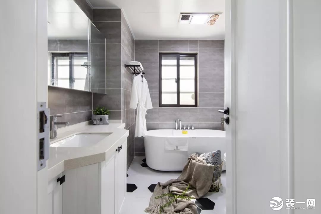  卫生间以简约的灰白色为主调，整体简洁优雅。地面的白色六边砖中加入了黑色块，跳脱出本身纯白的单一感。