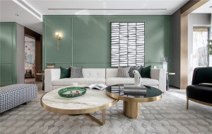 沙发墙以淡淡的茶绿色为背景，加入边框造型，挂一幅抽象派的灰白色装饰画，搭配米白色的布艺沙发，让空间充