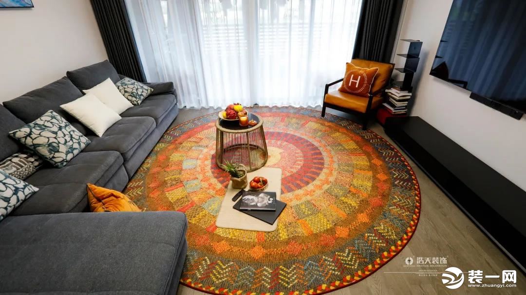 黄小姐在异国他乡淘来的巨大圆形地毯，占据了80%的客厅空间。一进门，眼光瞬间被明艳的它吸引住了