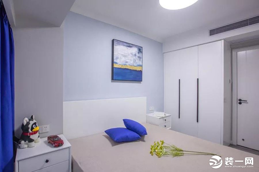 次卧作为长辈房使用，主要满足睡眠和贮物功能，以实用为主。淡蓝色墙漆自然温和，宝蓝亮色统一居室风格