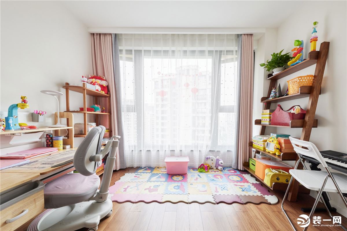 儿童房暂未设床，而是打造成了宝宝的阅读玩耍区。每个阶梯式置物架上有序放满了童书和玩具。