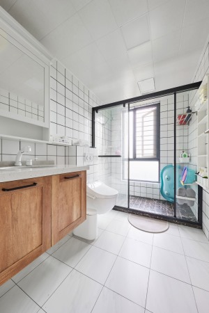 木色与白色搭配的卫浴空间，清新明亮。淋浴房以黑色金属线条包边，视觉上凸显出现代精致感。