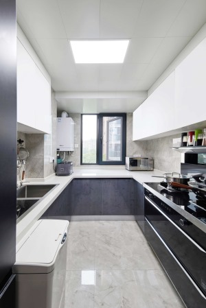 厨房空间结构相对狭长，设计成U型布局，紧凑又实用。黑白灰配色时尚大气，双层柜体让收纳更充足.