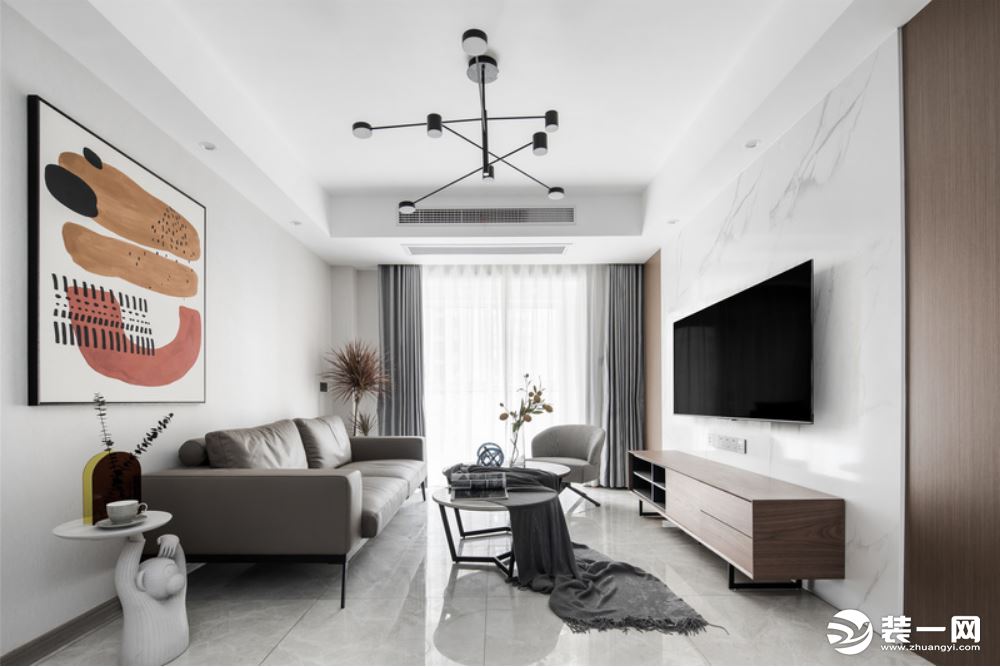 客厅整体空间以灰白调为主基调，线条简洁硬朗，奠定了空间低调的质感、优雅的基调。