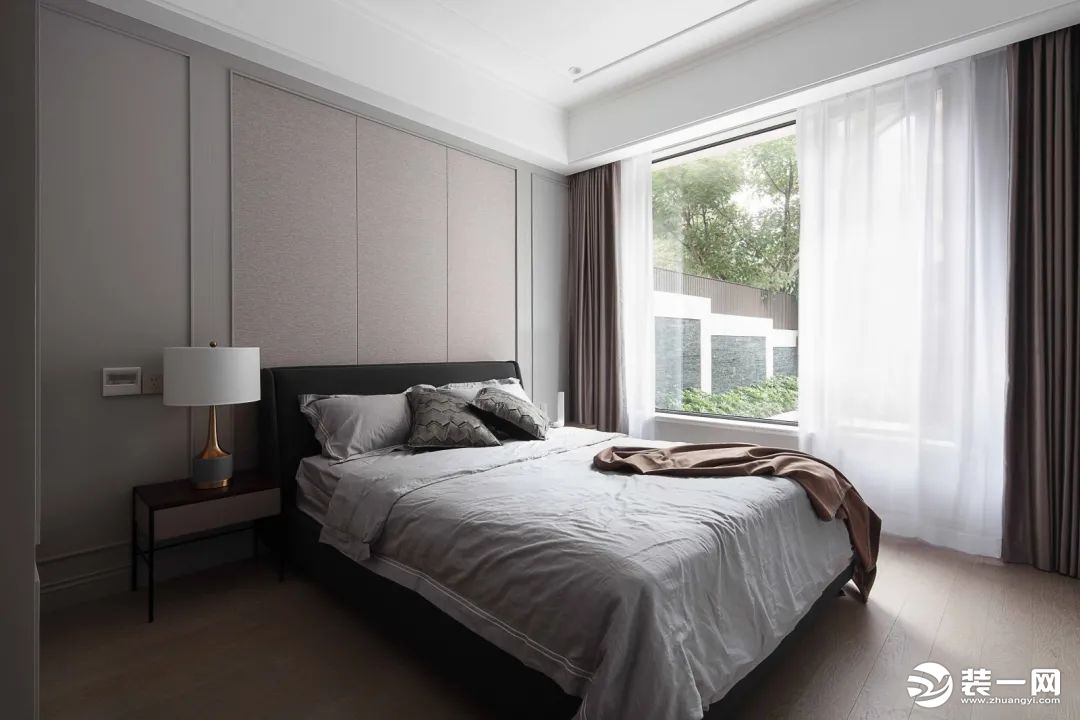 长辈房拉开落地窗帘便能尽览庭院生机，以深浅不一的灰色为基调，营造了一个别致、舒适、放松的卧室氛围。