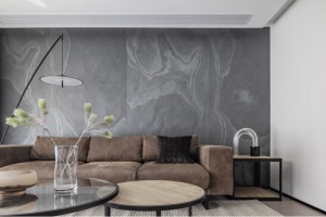 沙发背景墙铺贴了一款黑色的岩板，在颜值上更是设计感十足，使空间充满了惊艳的质感、现代感、极简感。