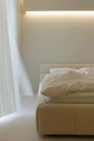 主卧以简单、舒适为主题，米色的床品和地板搭配暖色的灯光，使卧室的温馨感倍增，营造出宁静平和的休憩环境