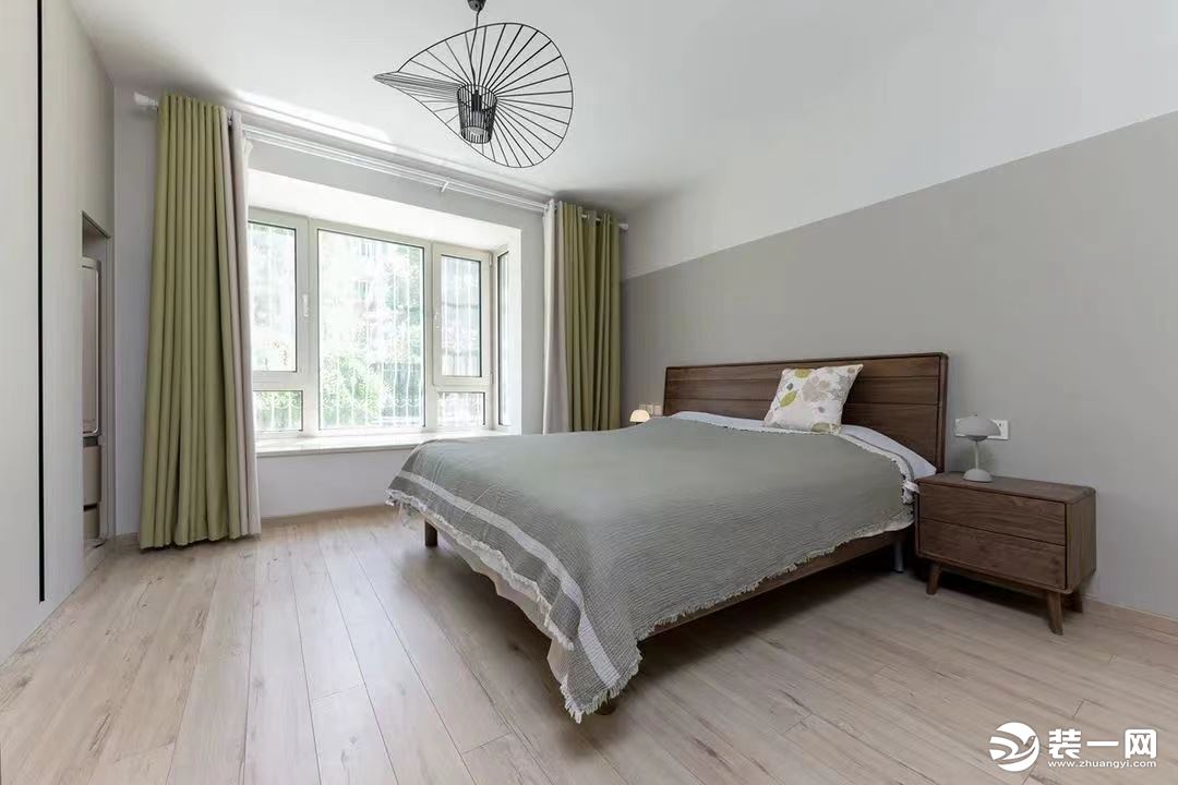主卧以低饱和度色彩为主，打造舒适无压的睡眠空间。浅灰色背景墙与床品相呼应，白色平顶与地板形成对比效果