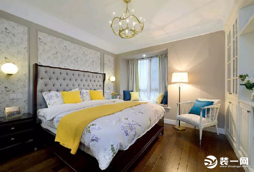 美式风格的舒适的大床，洁净的底色，整齐纯白的衣柜与黄色蓝色抱枕的点缀，温馨舒适，清新的格调尽显其中。