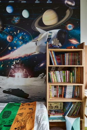 床边整墙的太空海报丰富了孩子的想象力，宇宙飞船、太空中转站、宇航员......让孩子仿佛置身在外太空