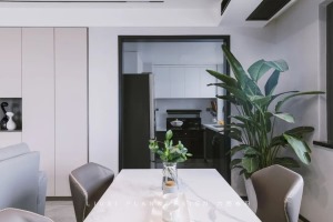南北通透的客餐厅，灰色系列的极简风，餐桌的白色大理石台面干净优雅，搭配黑色皮椅，衬托出空间的高级感。